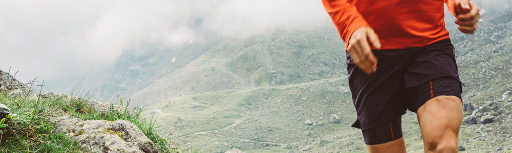 Torso of man running through a dusty trail Torso of man running through a dusty trail